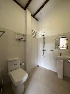 a bathroom with a toilet and a sink at Royal beach villa in Unawatuna