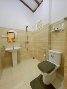 a bathroom with a toilet and a sink at Royal beach villa in Unawatuna +50 photos