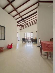 a large room with a table and chairs in it at Royal beach villa in Unawatuna