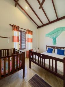 a bedroom with two bunk beds and a window at Royal beach villa in Unawatuna