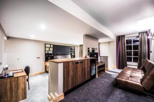 a living room with a couch and a table at Courthouse Hotel London in London