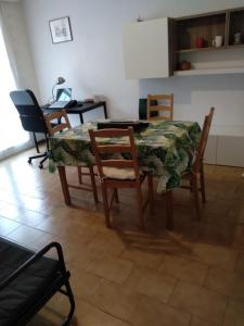 tavolo e sedie in cucina con tavolo e sedie e chaise longue di Appartamento di Olga a Lecco