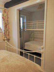 a bedroom with a bunk bed with a mirror at Little Park Holiday Homes Self Catering Cottages 1 & 2 bedrooms available close to Tutbury Castle in Tutbury