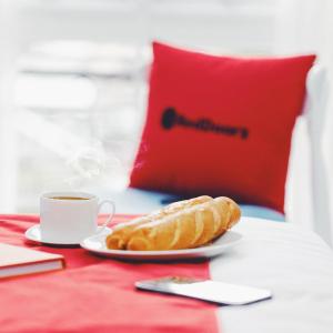 a plate of bread and a cup of coffee on a table at RedDoorz Bui Vien Walking Street in Ho Chi Minh City