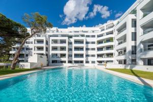 an apartment building with a swimming pool in front of it at VACATION MARBELLA I Via Celere, Huge Terrace, Brand New Complex, Close to the Beach, Marbella Center in Marbella