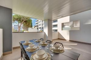 a dining room with a blue table and chairs at VACATION MARBELLA I Via Celere, Huge Terrace, Brand New Complex, Close to the Beach, Marbella Center in Marbella