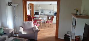 a living room with a couch and a table with chairs at FeWo Trientje in Uplengen