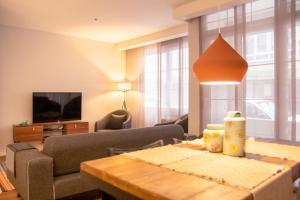 a living room with a couch and a table at Flat Close to Beach in Karsiyaka in Izmir