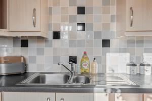 a kitchen with a sink and a counter top at Cosy countryside apartment in Wellingborough