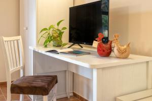 TV o dispositivi per l'intrattenimento presso Alghero Resort Country Hotel & Spa