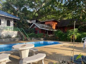 a patio with a table and chairs next to a pool at Lonely Beach Pool Resort in Ko Chang