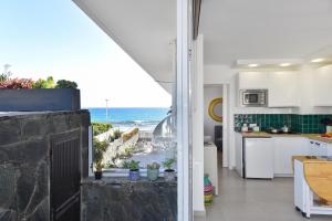 a kitchen with a view of the ocean at Apartment La Maresia CB9A by VillaGranCanaria in San Agustin