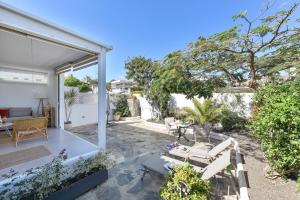 a patio of a house with a table and chairs at Apartment La Maresia CB9A by VillaGranCanaria in San Agustin