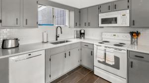 a kitchen with white cabinets and white appliances at 57 North Lynx Condo Condo in Warren