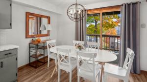 a dining room with a white table and chairs and a window at 57 North Lynx Condo Condo in Warren