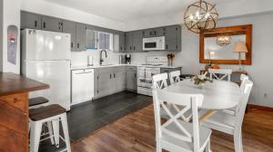 a kitchen with a white refrigerator and a table at 57 North Lynx Condo Condo in Warren
