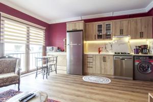 a kitchen with a refrigerator and a table with chairs at Charming Flat near Kennedy Avenue in Fatih in Istanbul