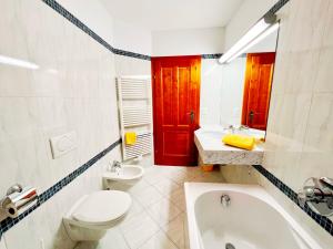 a bathroom with a toilet and a sink and a tub at Ferienwohnung Südblick in Bad Kleinkirchheim +19 photos