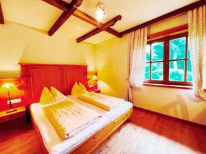 a bedroom with a bed and a large window at Ferienwohnung Südblick in Bad Kleinkirchheim