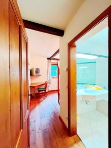 a room with a bathroom with a sink and a desk at Ferienwohnung Südblick in Bad Kleinkirchheim