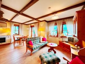 a living room with a couch and a table at Ferienwohnung Südblick in Bad Kleinkirchheim