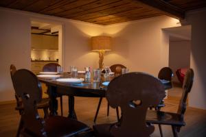uma sala de jantar com uma mesa de madeira e cadeiras em Uncle Eric's Chalet em Matten