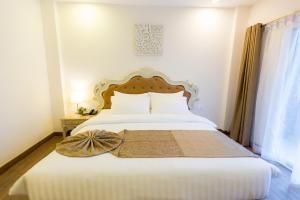 Voodi või voodid majutusasutuse Hi Chiangrai Hotel toas