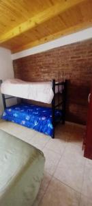 a room with two bunk beds and a wooden ceiling at Departamento en Trelew in Trelew +2 photos