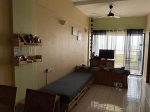 a room with a bed and a tv in it at Port Dickson Paradise Lagoon Beachfront Apartment in Port Dickson