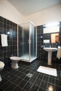 a bathroom with a toilet and a sink and a shower at Hotel Zephyr - Plovanija in Buje