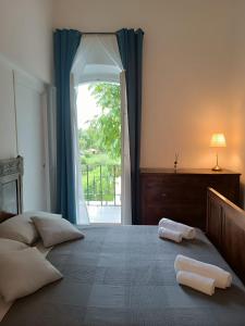 a bedroom with a large bed with two towels on it at b & b ultimo miglio in Treviso