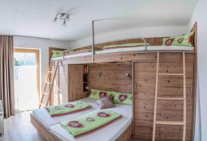 a bedroom with two bunk beds and a ladder at Pirchachhof in Wenns