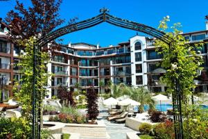 a hotel with an arch in front of a building at Boutique Rose Gardens Pomorie in Pomorie