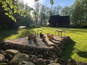a fire pit in the middle of a yard at Mednieku Namiņš in Sigulda