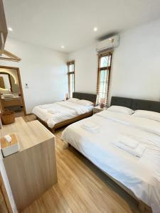 Postel nebo postele na pokoji v ubytování Club House Khao Kho