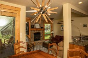 a living room with a ceiling fan and a fireplace at 6532 Settlers Creek Condo in Keystone