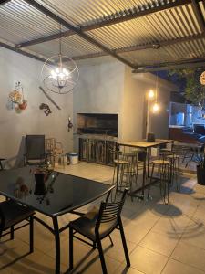 a dining room with tables and chairs and a piano at a termas voy in Termas de Río Hondo
