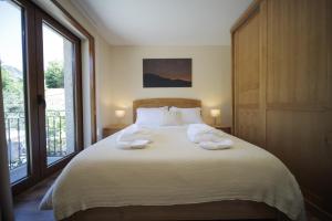 a bedroom with a bed with two towels on it at Casa da Fonte - Gerês in Geres