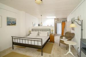 a bedroom with a bed and a table and a chair at Usedom Refugium in Zinnowitz