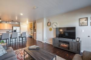 a living room with a television and a fireplace at First Tracks 3303 Condo in Steamboat Springs