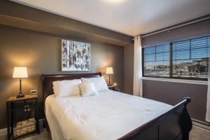 a bedroom with a large bed and a window at First Tracks 3303 Condo in Steamboat Springs +22 photos