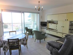 un soggiorno con divano, tavolo e sedie di Appartement Morvan a Sarzeau