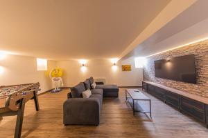 a living room with a couch and a tv at le Foncillion in Royan