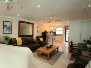 a living room with a couch and a table at Beach Road Studio in Cape Town