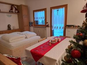 a bedroom with a christmas tree and a bed at La Casa degli Gnomi in Falcade