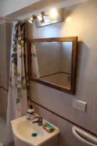 a bathroom with a sink and a mirror and a toilet at Departamento 2 ambientes a estrenar in Buenos Aires +21 photos