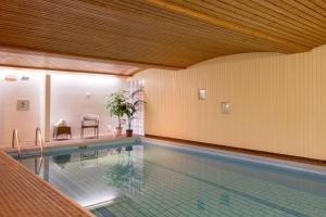 a large swimming pool in a large room with at Landhotel Lortz in Reichelsheim