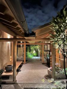 un patio con tavolo e un edificio con di 萌蘖　露天風呂とサウナがある現代の湯治場 a Kagoshima