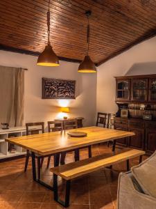 a dining room with a wooden table and chairs at Casa da Terra Nova - Gerês in Rio Caldo
