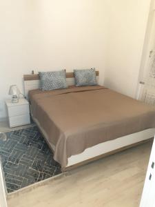 a bedroom with a large bed with two pillows at LOVE Appartement partagé avec le proprietaire in Saint-Louis